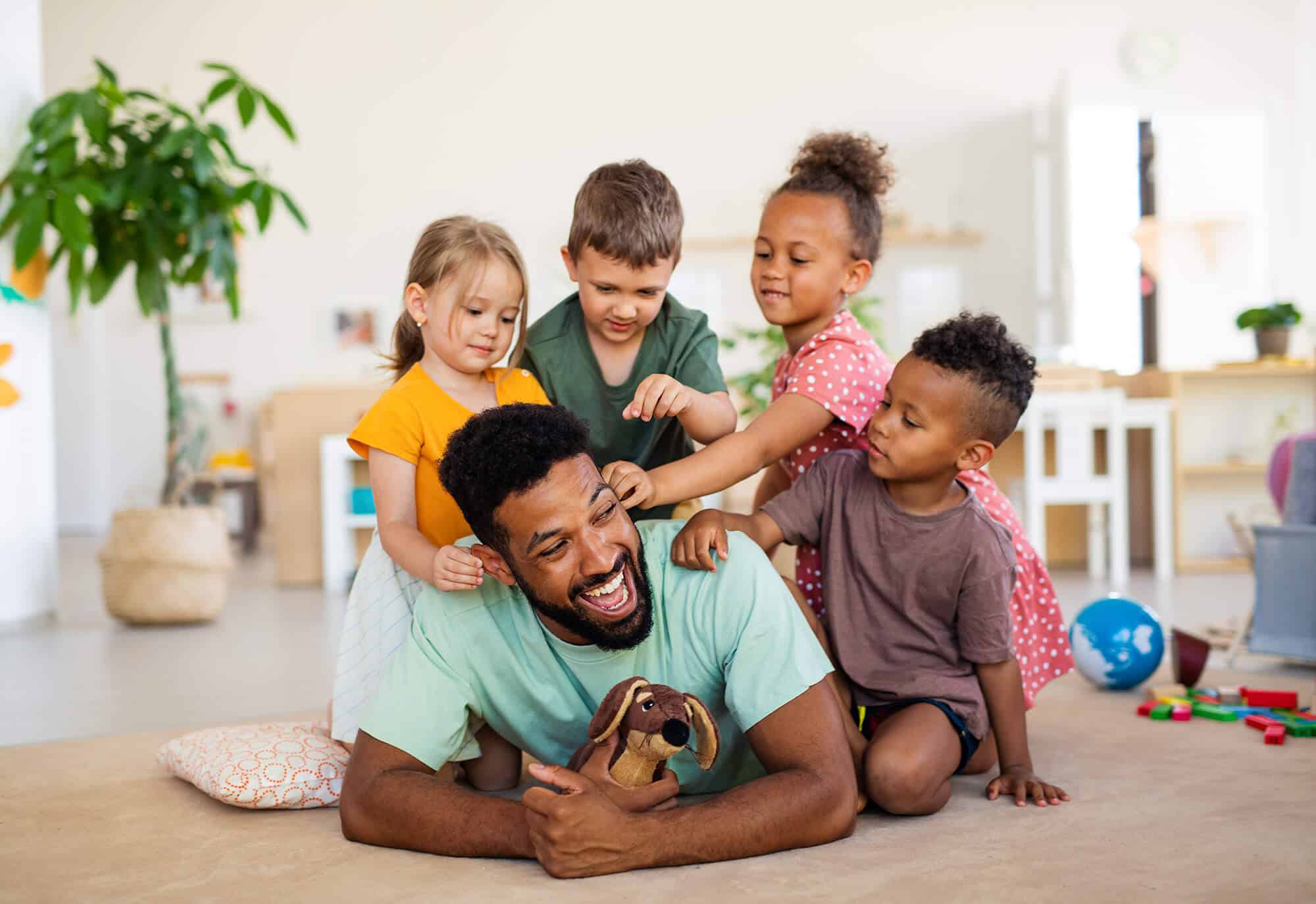 nursery-school-children-with-man-teacher-sitting-o-2023-11-27-04-52-10-utc.jpg